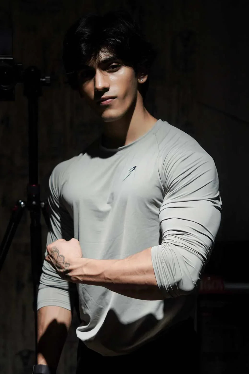Light grey Bare Nylon full-sleeve T-shirt by Fuaark Nz, showing the shirt's fit and fabric texture.