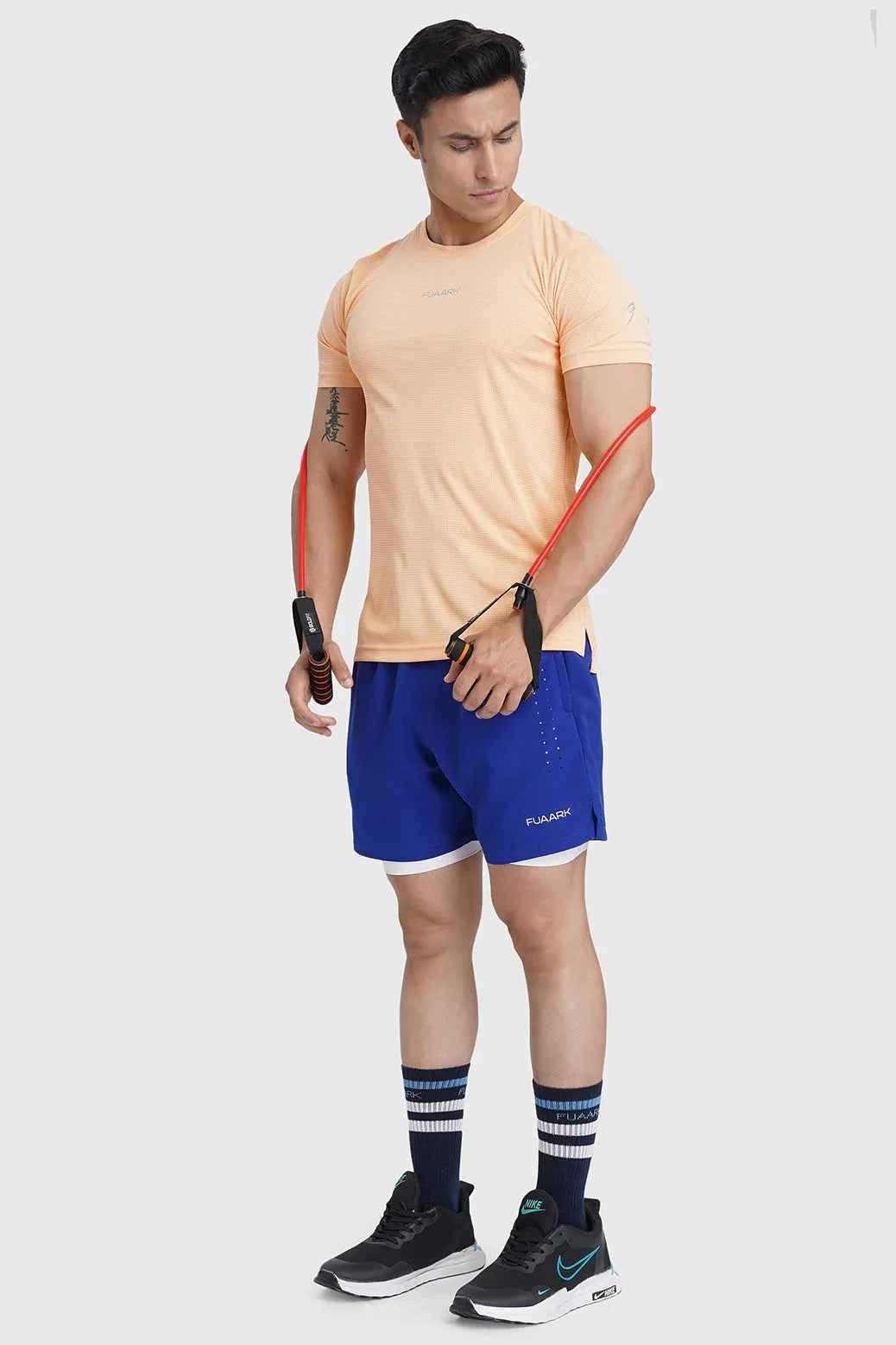 Fuaark NZ Checks Running T-shirt in peach with a checkered pattern, designed for comfort and activewear.