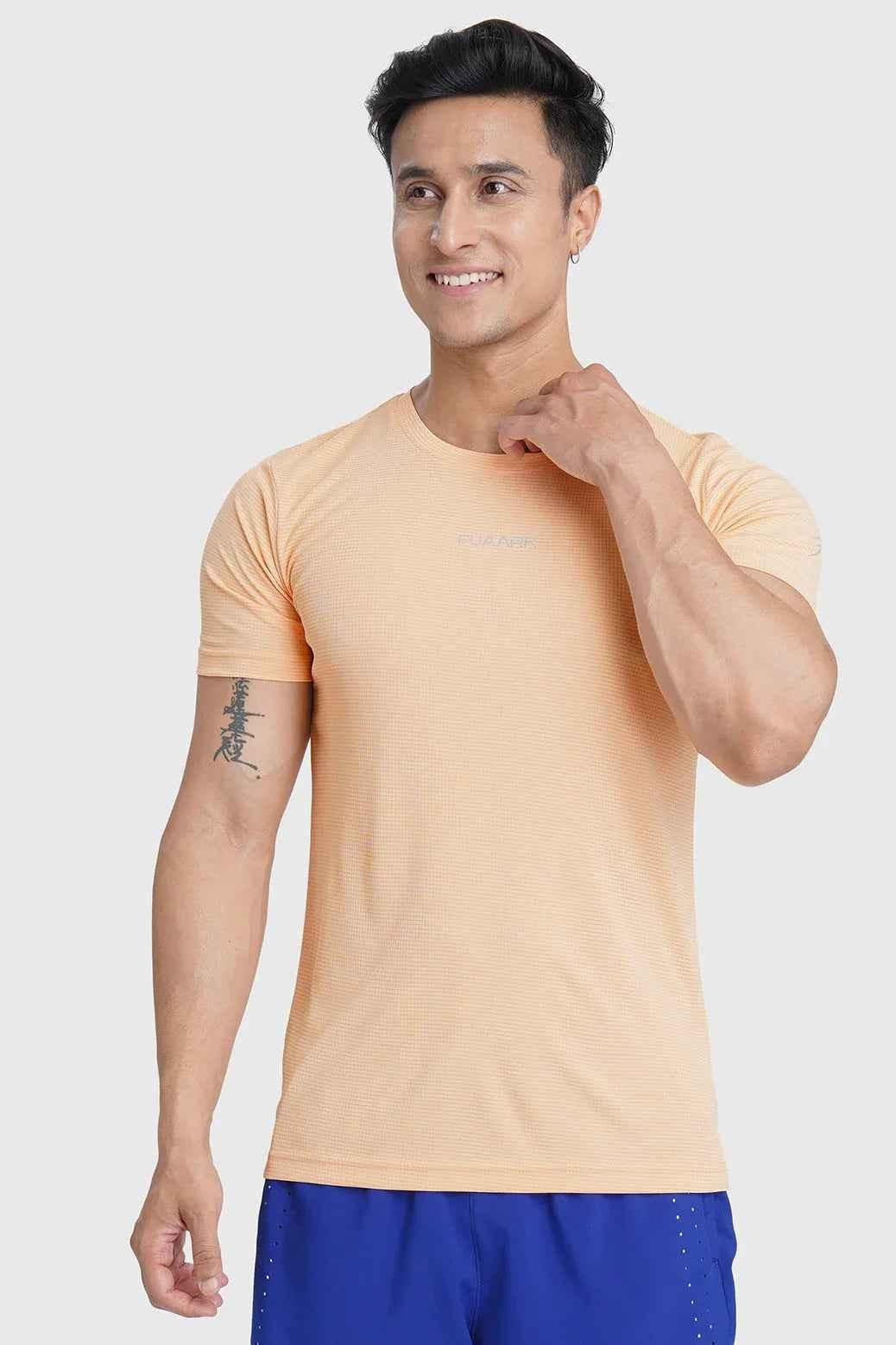 Fuaark Nz Checks Running T-shirt in peach color with a casual fit and checkered pattern, designed for active wear.