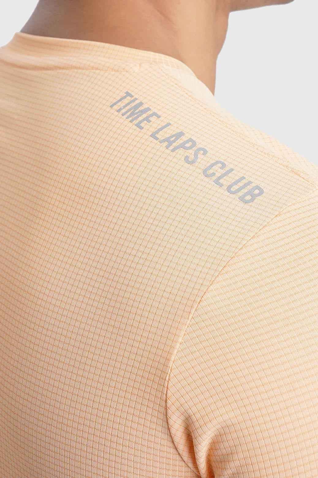 Fuaark Nz Checks Running T-shirt in peach color, featuring a casual fit and breathable fabric, designed for active wear.