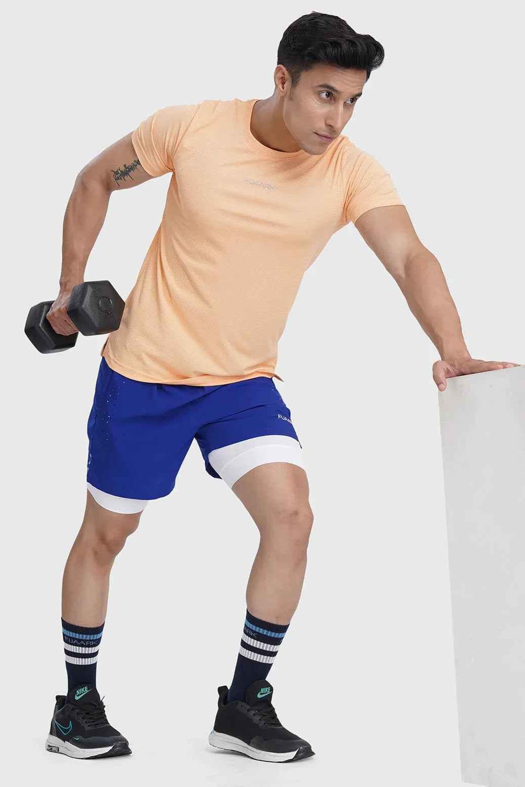 Fuaark Nz Checks Running T-shirt in peach with a stylish checkered pattern, made for comfortable activewear.