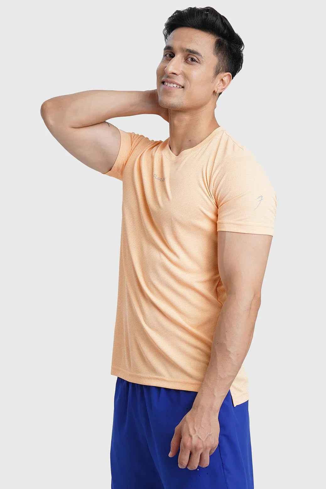 Fuaark Nz Checks Running T-shirt in peach, short-sleeve athletic top with checkered pattern for active wear and casual style.