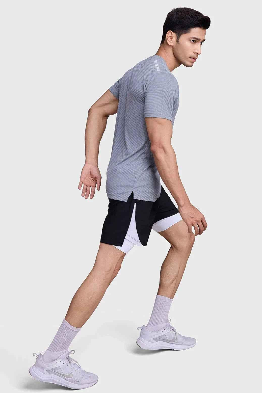 Checkered Fuaark Nz running T-shirt in ultimate grey, lightweight athletic top with breathable fabric for active wear.