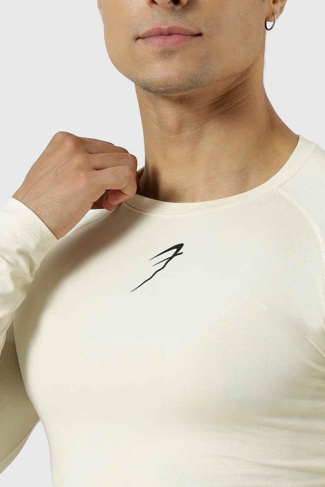 Beige compression full-sleeves T-shirt by Fuaark NZ, snug fit with smooth fabric, designed for active wear and comfort.