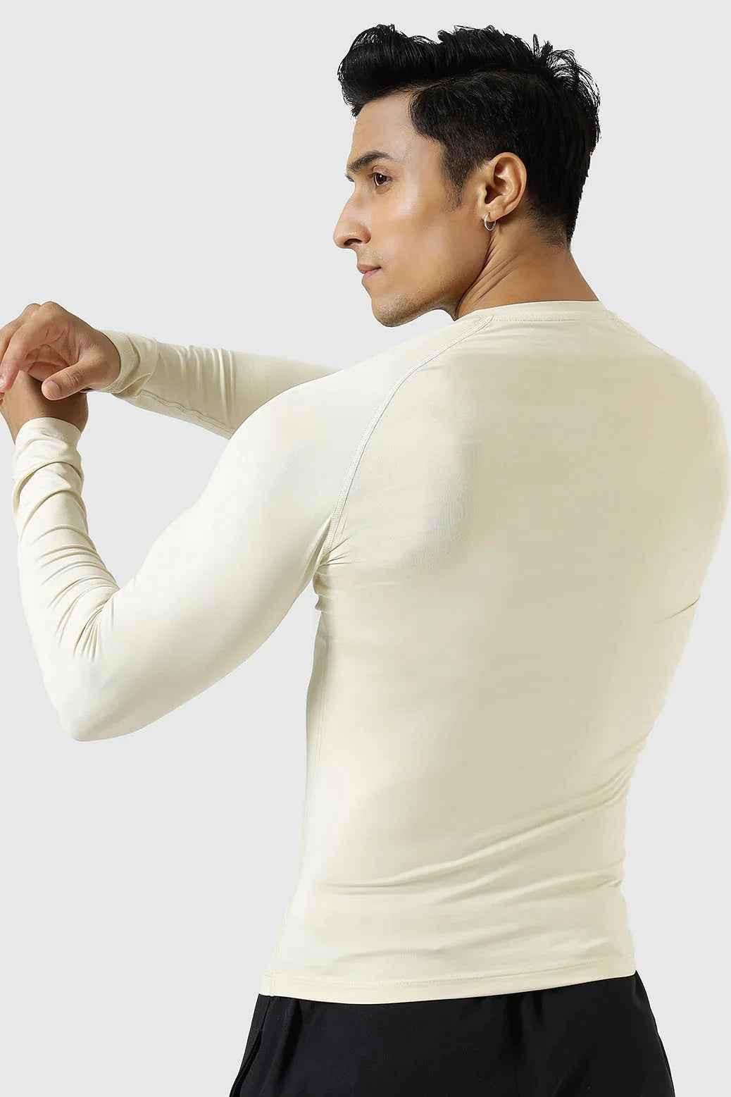 Beige compression full-sleeves T-shirt by Fuaark Nz, made of stretchy fabric, worn on a model's upper body.