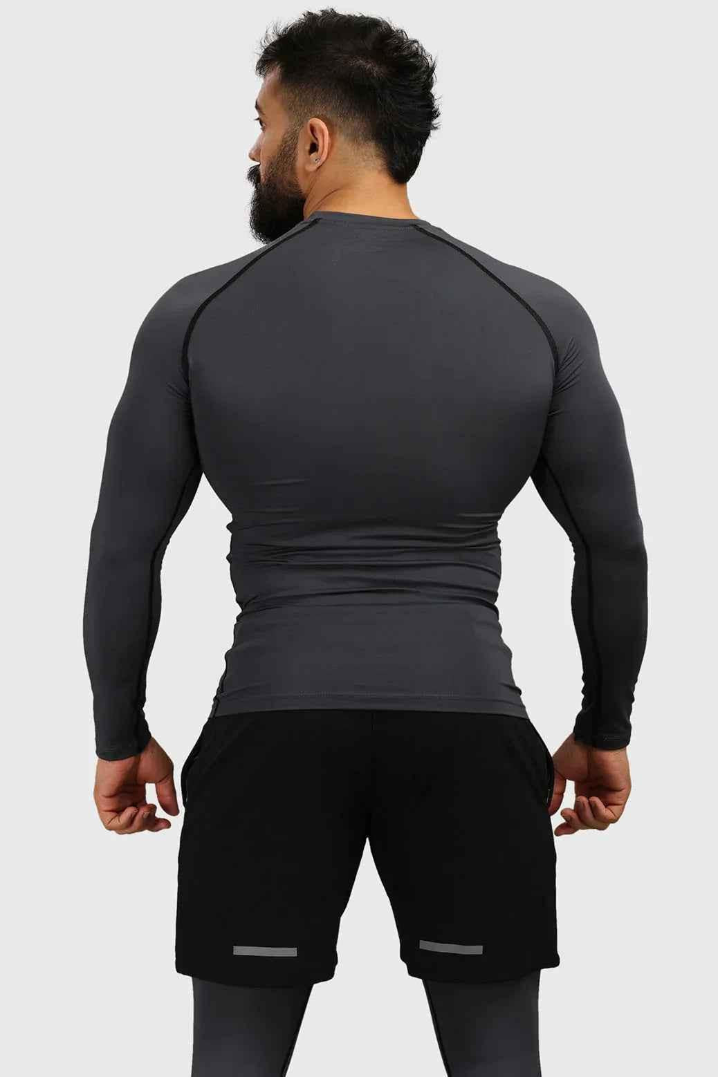 Grey compression fullsleeves T-shirt by Fuaark Nz, shown on a model highlighting the snug fit and athletic design.
