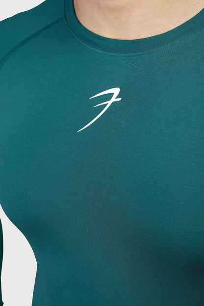 Fuaark Nz compression full-sleeve T-shirt in emerald green, designed for comfort and performance, shown on a model.