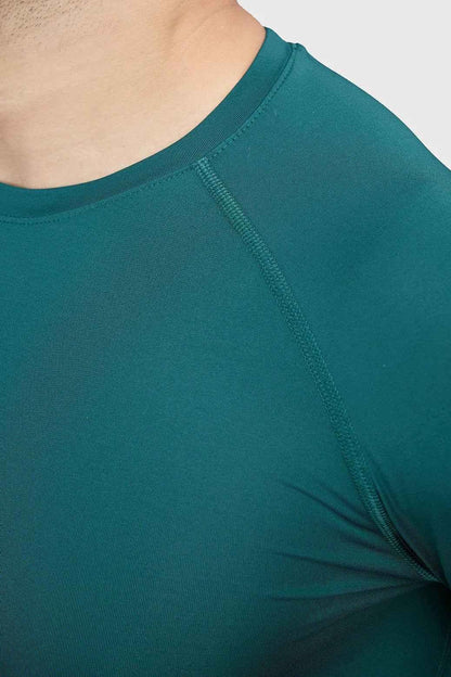 Fuaark Nz compression fullsleeves T-shirt in emerald green, designed for comfort and performance, shown on a model.