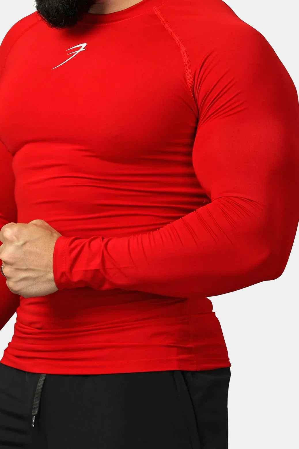 Red Fuaark Nz compression full-sleeves T-shirt displayed on a mannequin, showcasing its fitted design and vibrant color.