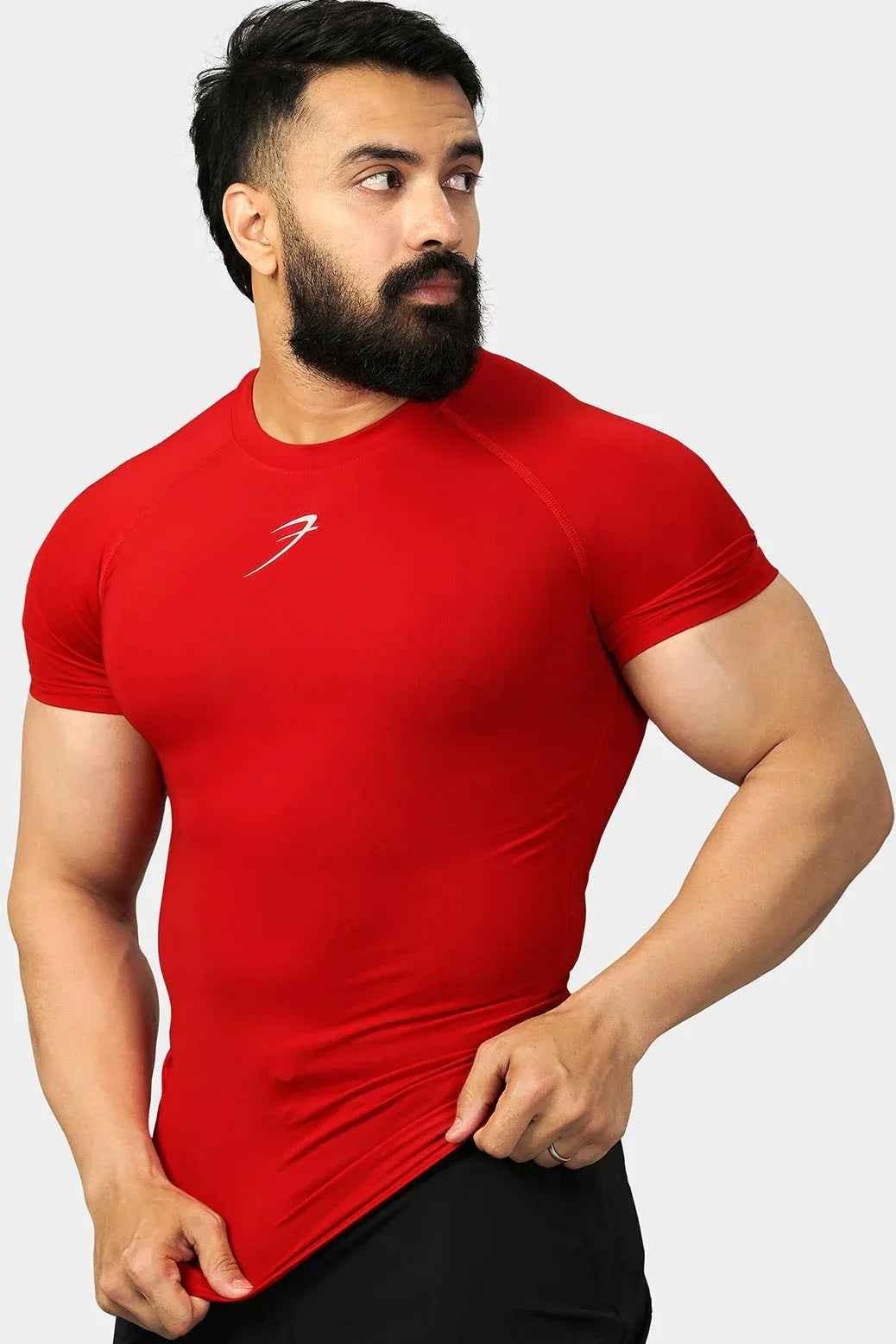 Red compression T-shirt by Fuaark Nz, designed for enhanced performance and comfort, shown on a model.