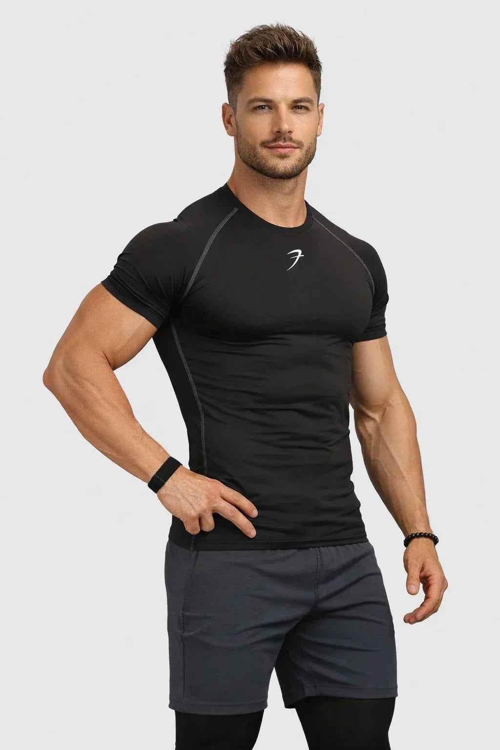 Black compression T-shirt from Fuaark Nz, shown on a mannequin, highlighting its fitted design and breathable fabric.