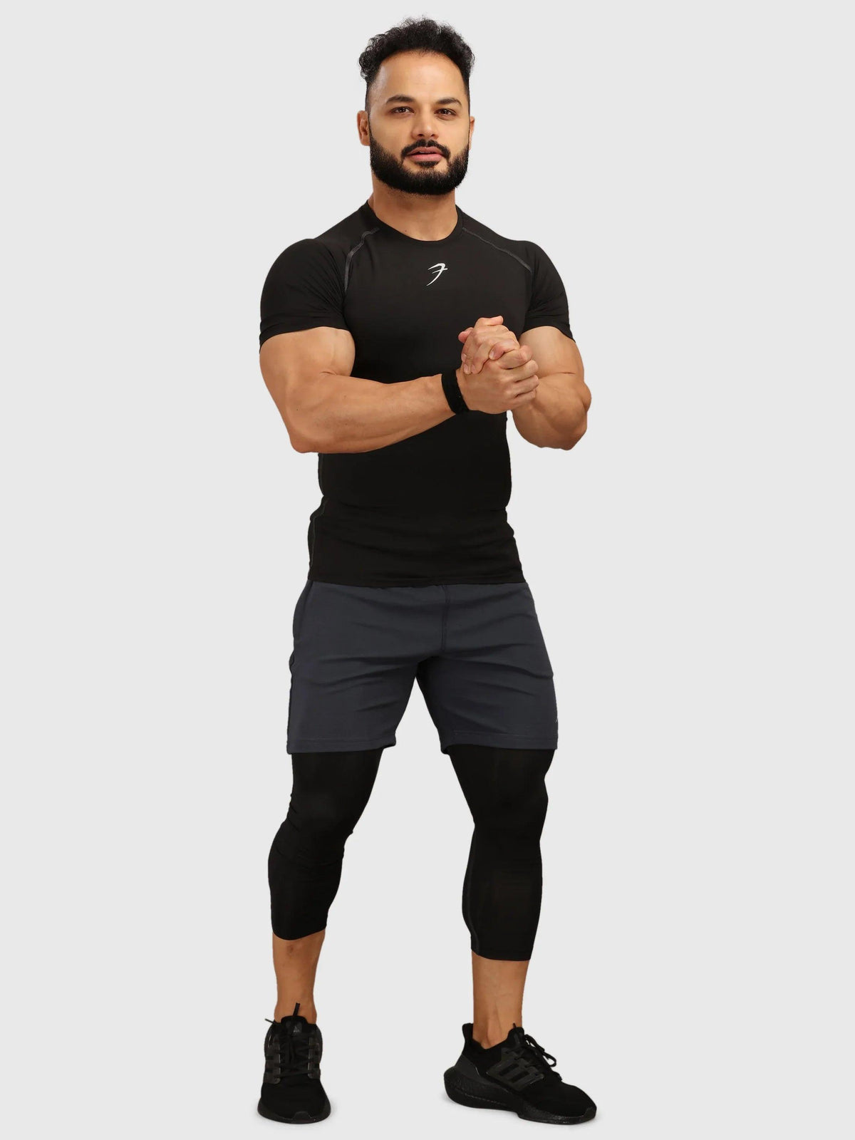 Black Fuaark Nz compression T-shirt for men, close-up view showing fitted design and smooth fabric.