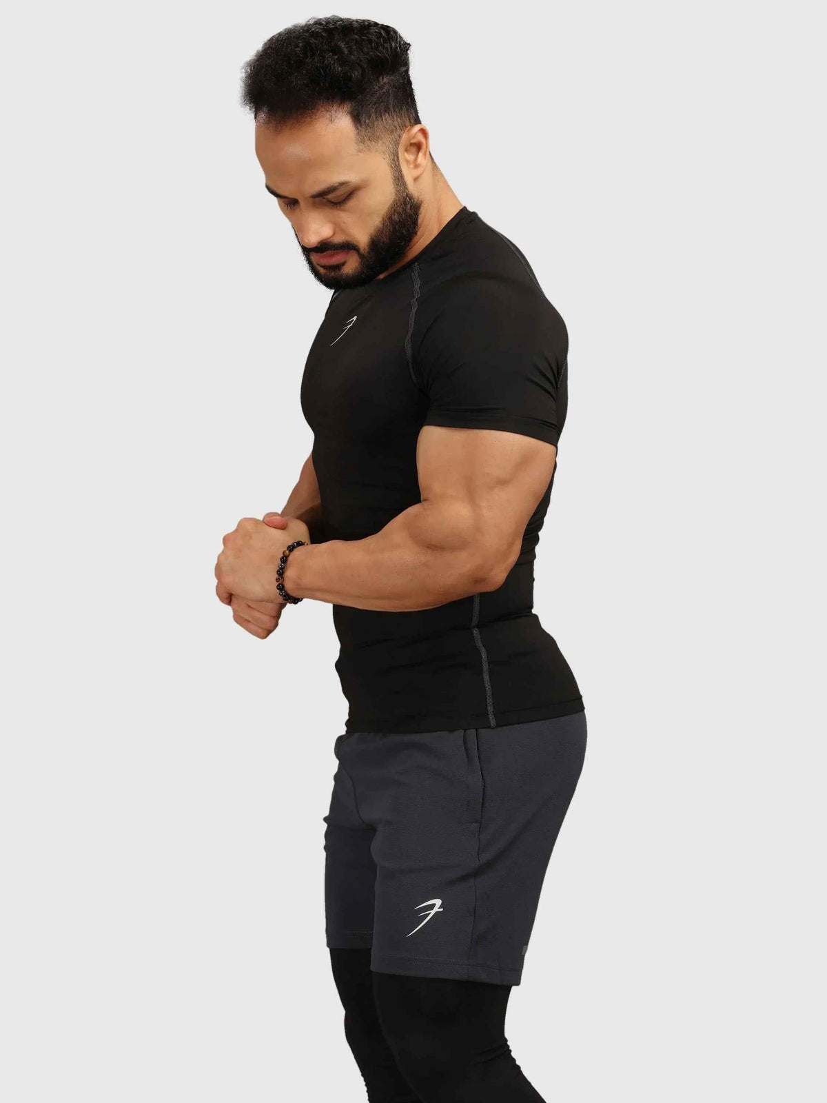 Black compression T-shirt by Fuaark Nz featuring a snug fit and athletic style, perfect for workouts and active wear.