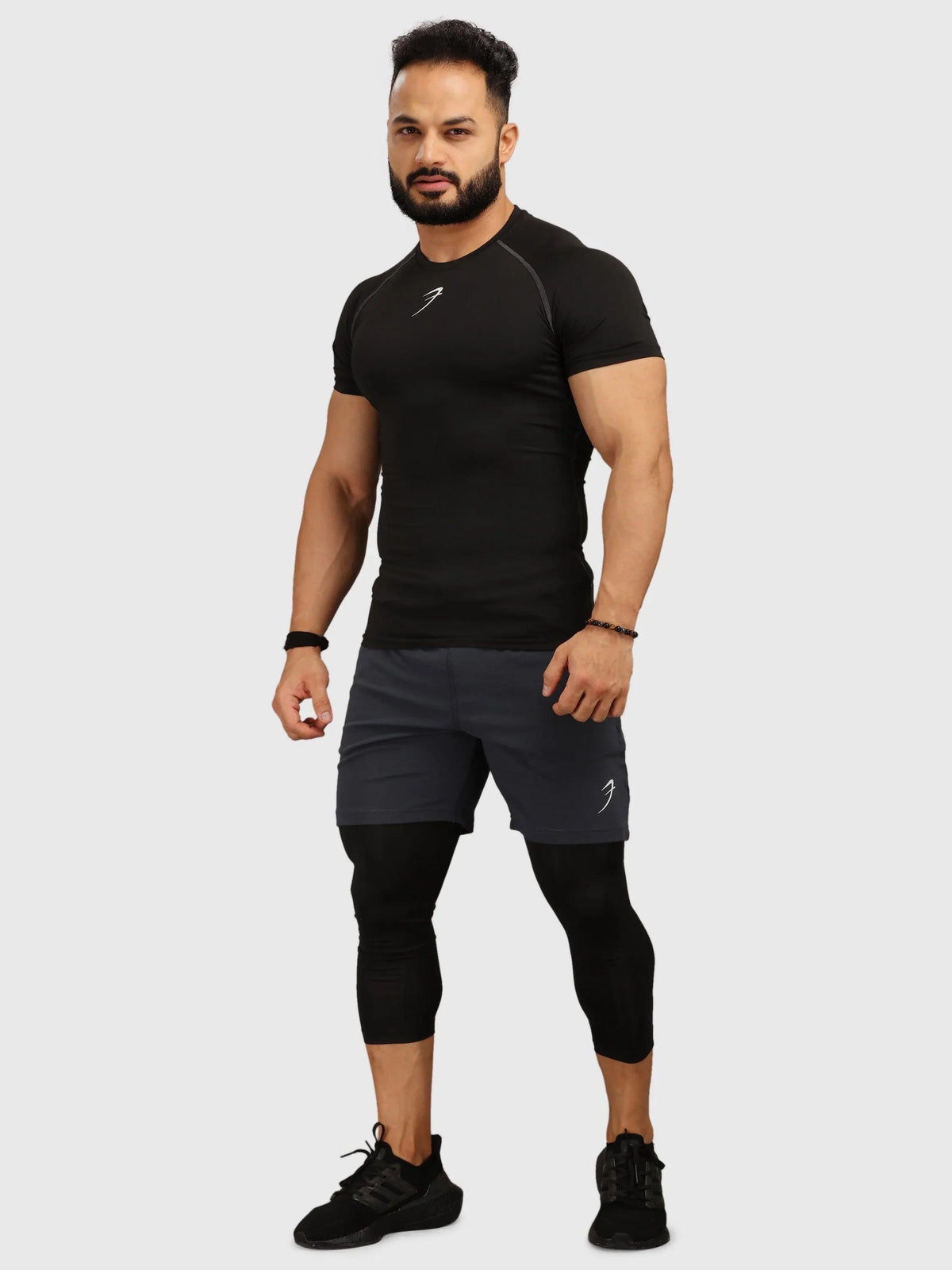 Black Fuaark Nz compression t-shirt for men, shown laid flat with short sleeves and fitted design.