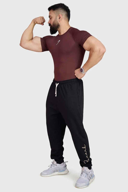 Brown Fuaark Nz compression T-shirt, close-up of fitted athletic shirt made from stretchy fabric with branding details.