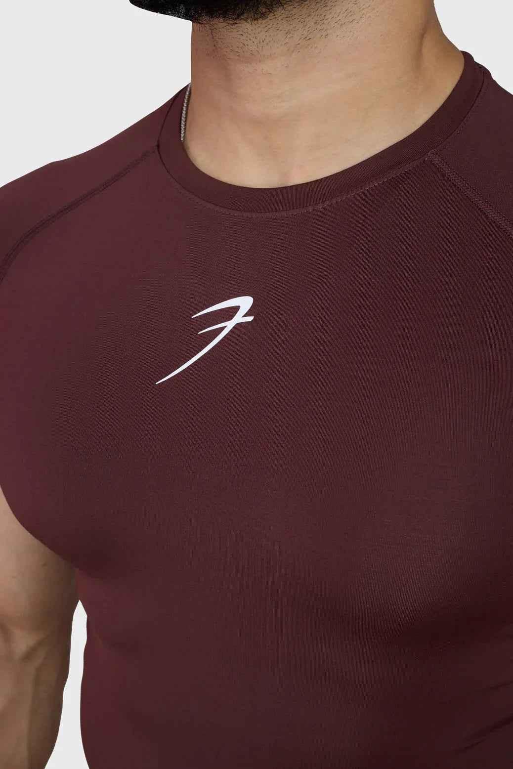 Fuaark Nz brown compression T-shirt for men, lightweight and fitted, showing the snug fit and material texture.