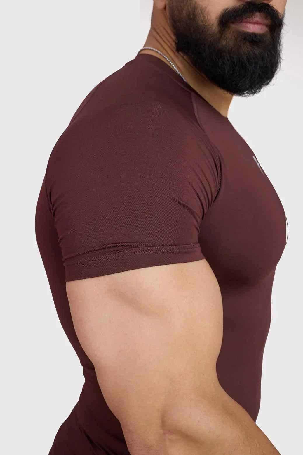 Fuaark NZ brown compression T-shirt for men, close-up view showing fitted athletic design and soft fabric texture.