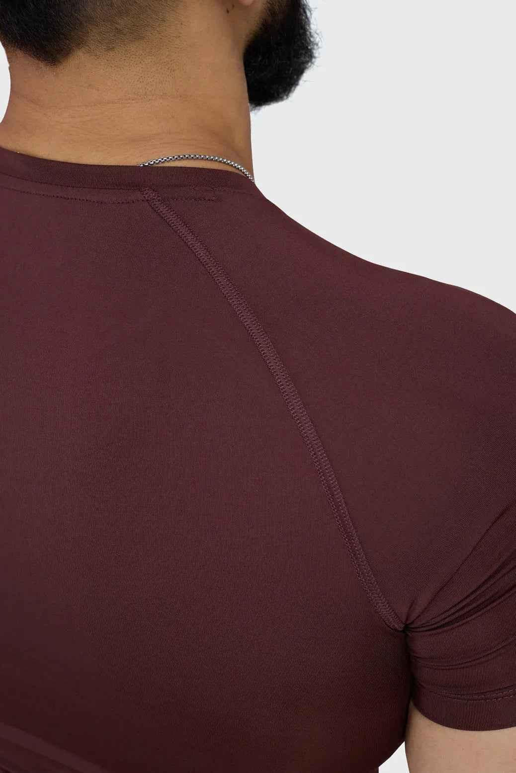 Fuaark Nz brown compression T-shirt for men, snug fit, made of stretchy fabric, designed for activewear and performance.
