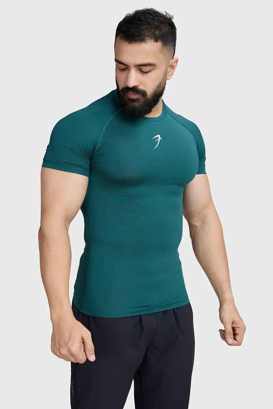 Fuaark Nz compression T-shirt in vibrant emerald green, fitted athletic shirt for enhanced support and performance.