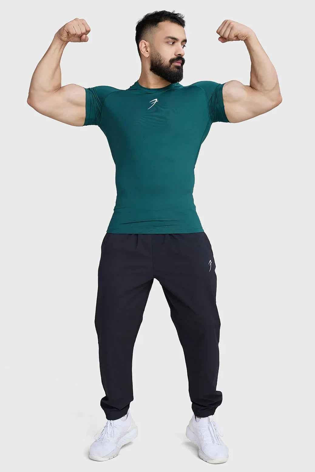 Emerald green compression T-shirt by Fuaark Nz, fitted athletic shirt with short sleeves and crew neckline.