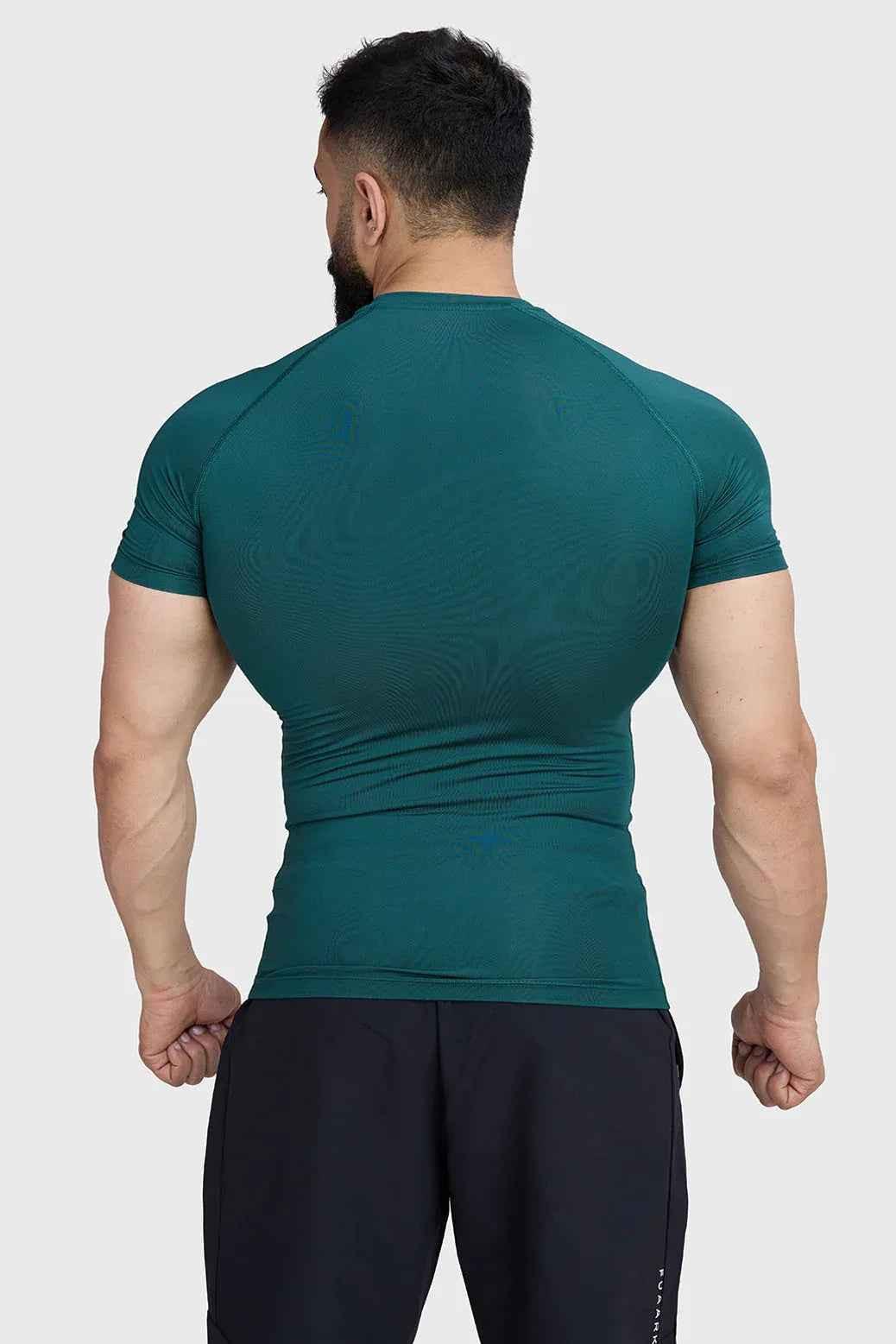 Fuaark Nz emerald green compression T-shirt for men, fitted athletic shirt with moisture-wicking fabric and short sleeves.