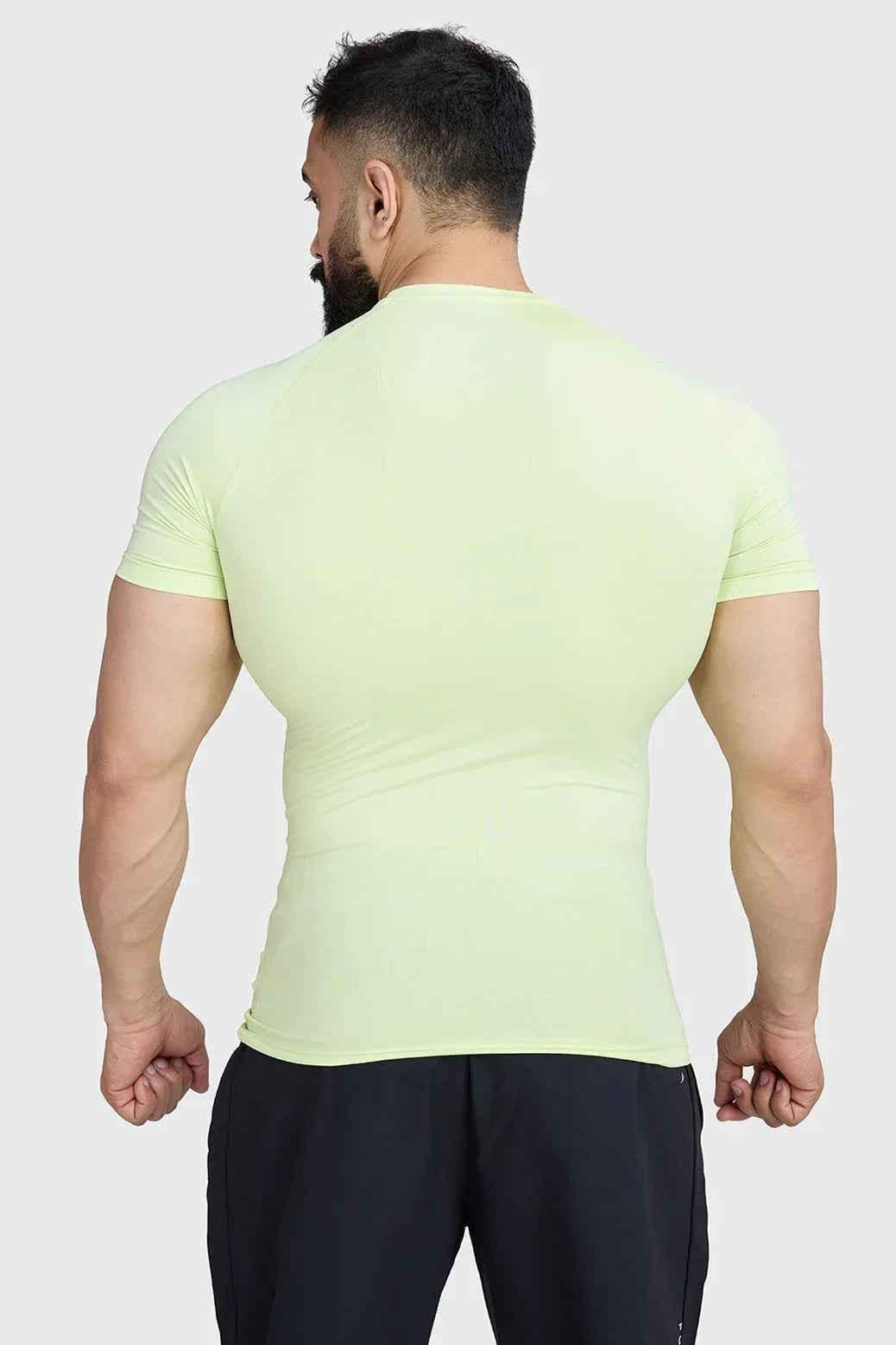 Fuaark Nz lime compression T-shirt for men, close-up of fitted athletic shirt with logo and moisture-wicking fabric.