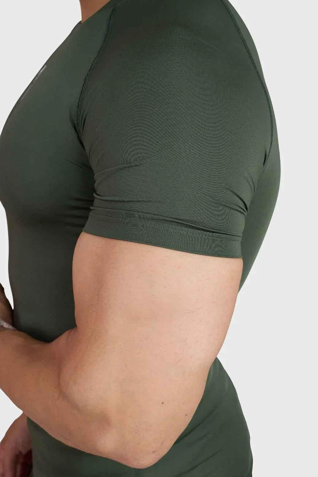 Olive green Fuaark Nz compression T-shirt for men, fitted and stretchy athletic shirt with short sleeves.