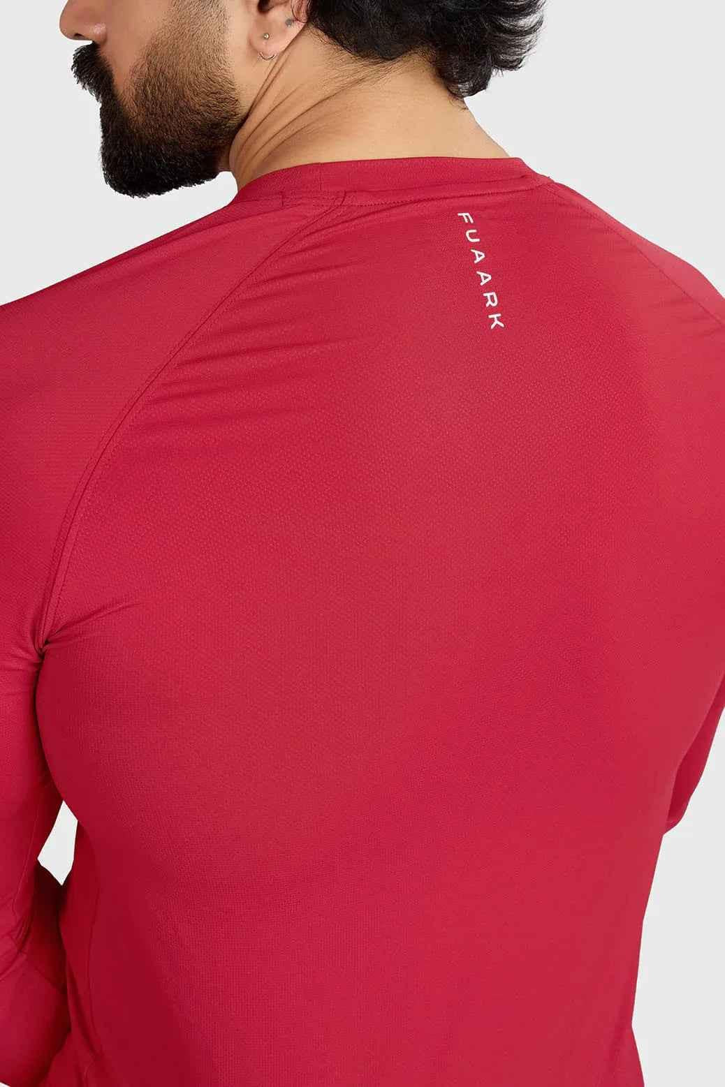 Red Fuaark Nz Core full-sleeves T-shirt with a fitted design, casual style, and visible branding on the front.