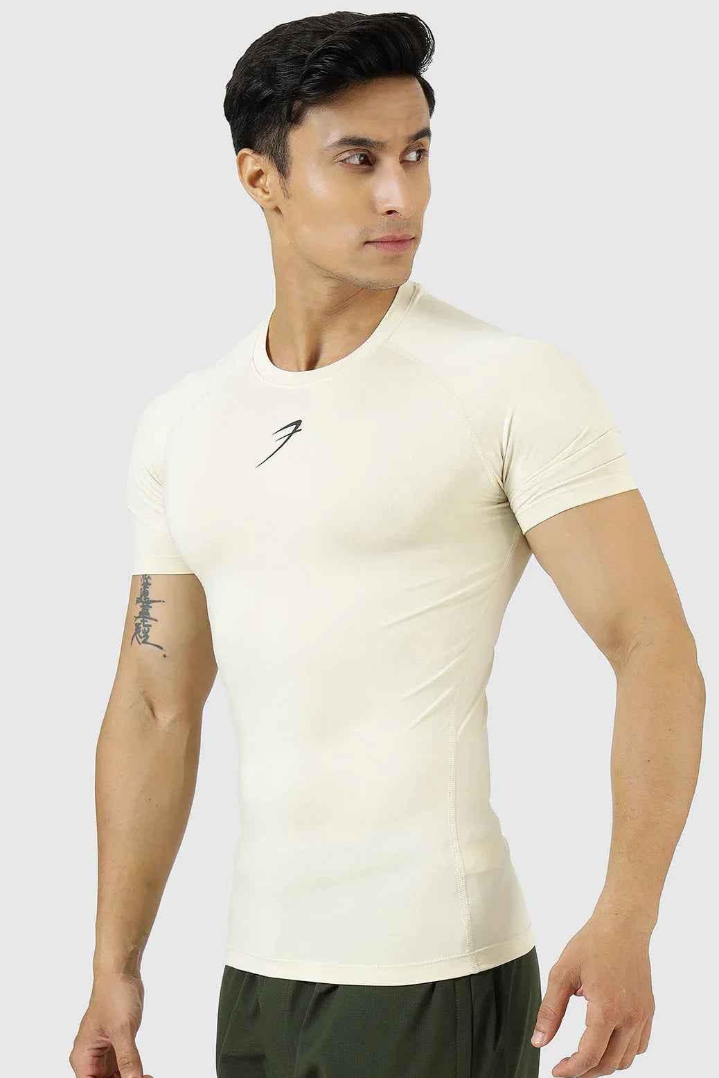 Beige compression T-shirt by Fuaark Nz, designed for athletic performance and comfort, shown on a model.