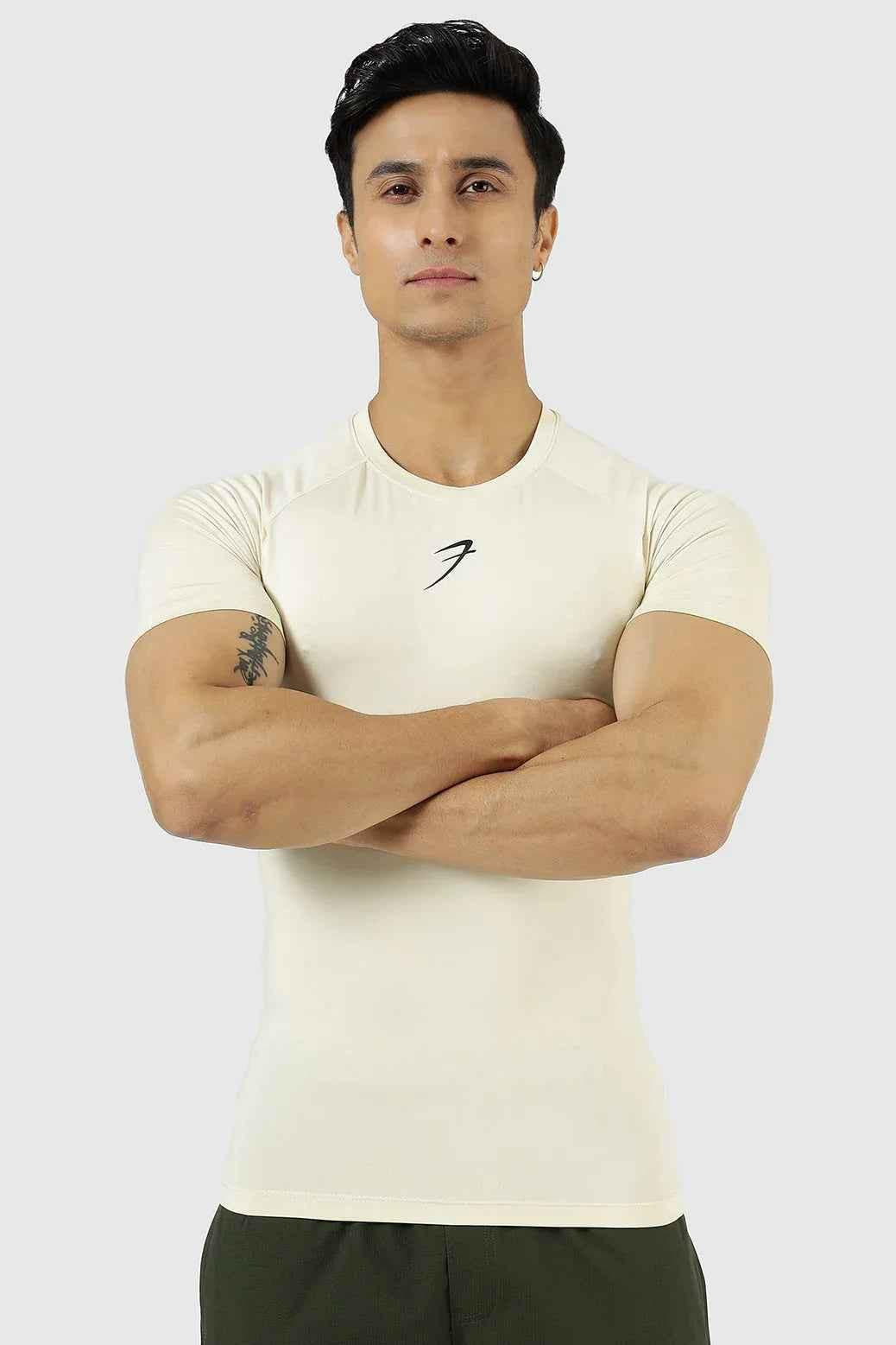 Beige compression T-shirt by Fuaark Nz, designed for athletic performance, shown on a model highlighting the fit and fabric texture.