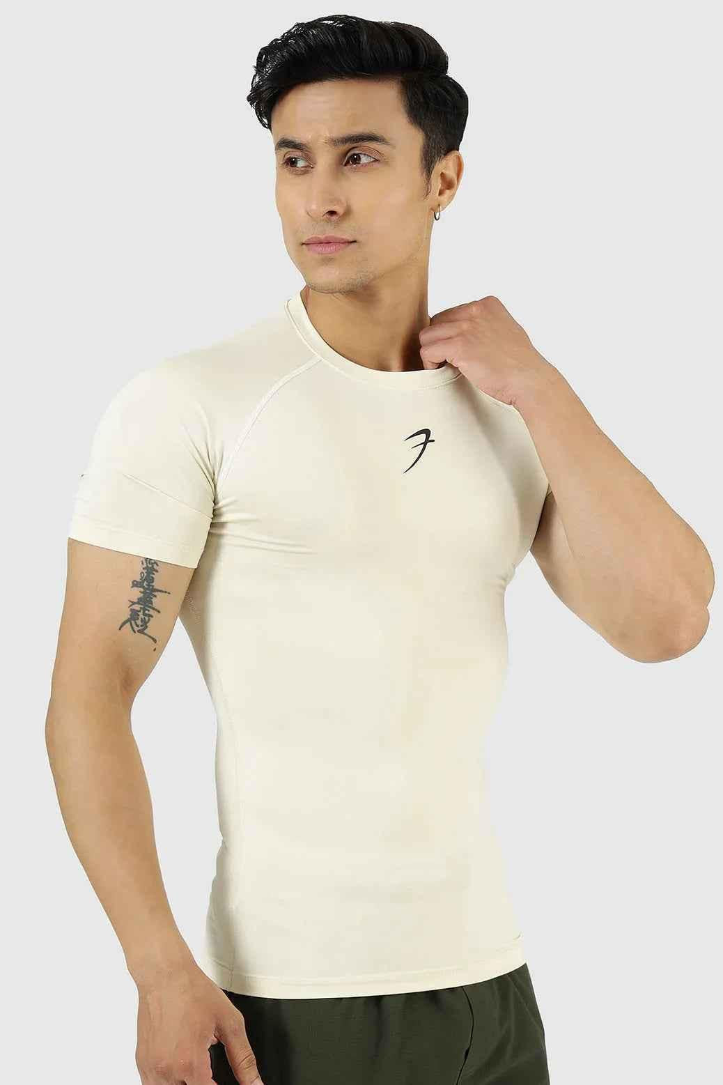 Beige compression T-shirt by Fuaark Nz, designed for athletic performance and comfort, shown on a model.
