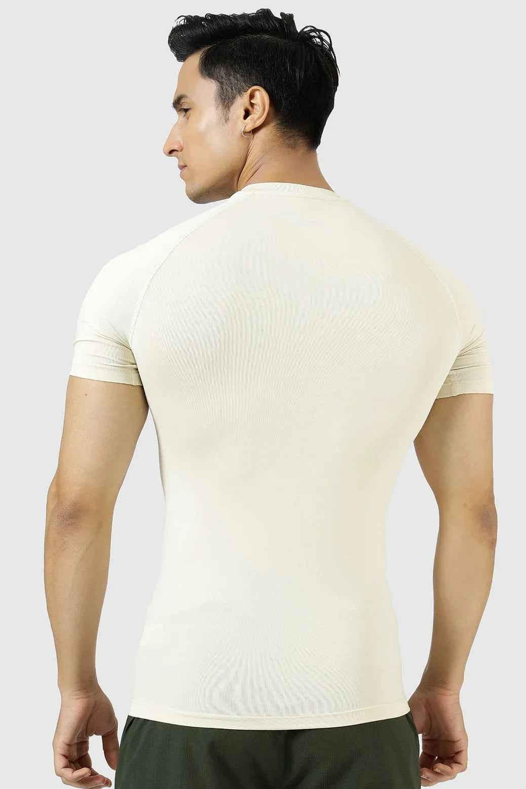 Beige Fuaark Nz compression T-shirt for men, designed for athletic performance and comfort, shown on a model.