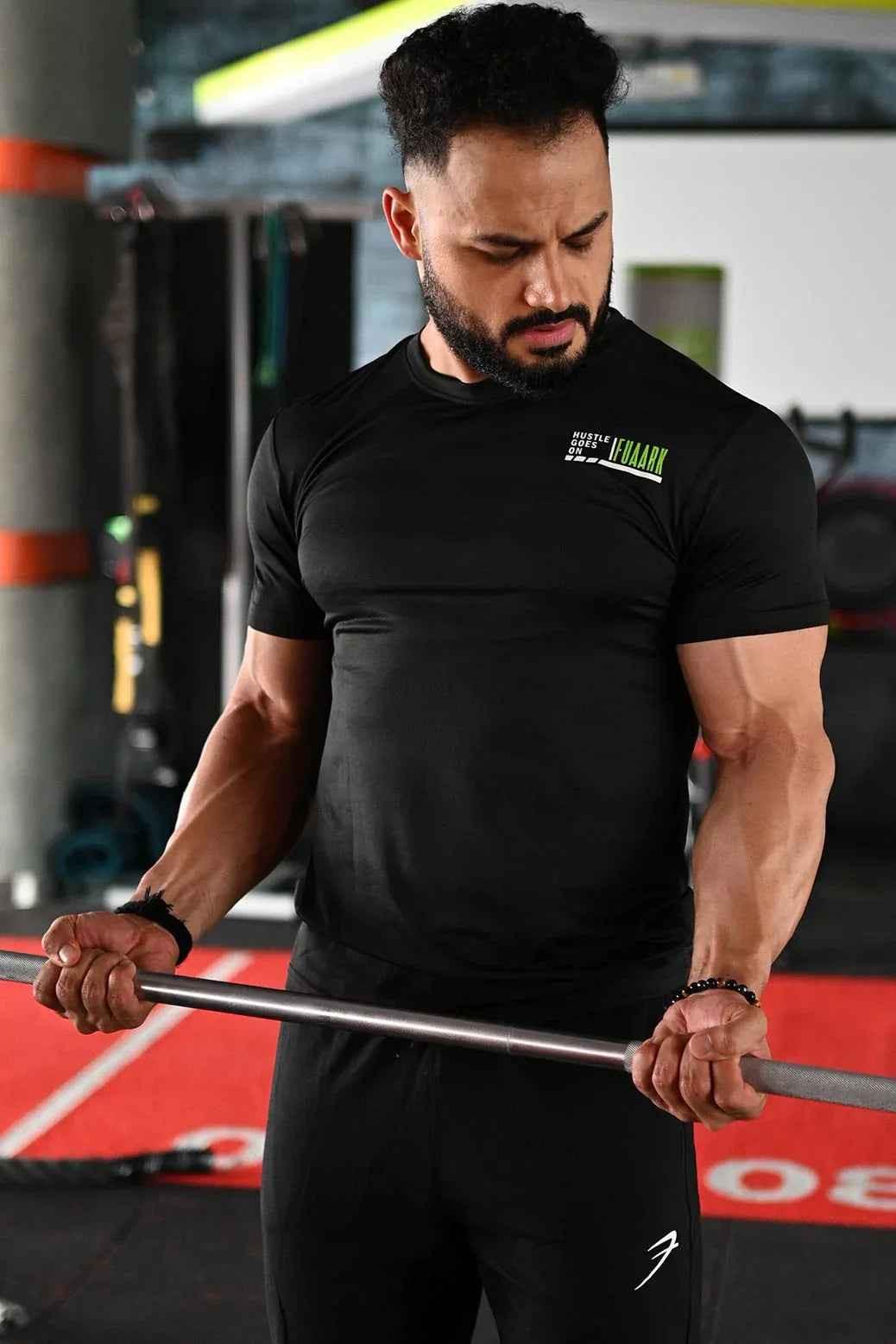 Black T-shirt from Fuaark Nz featuring a bold emblem design on the front. Made from comfortable, casual fabric.