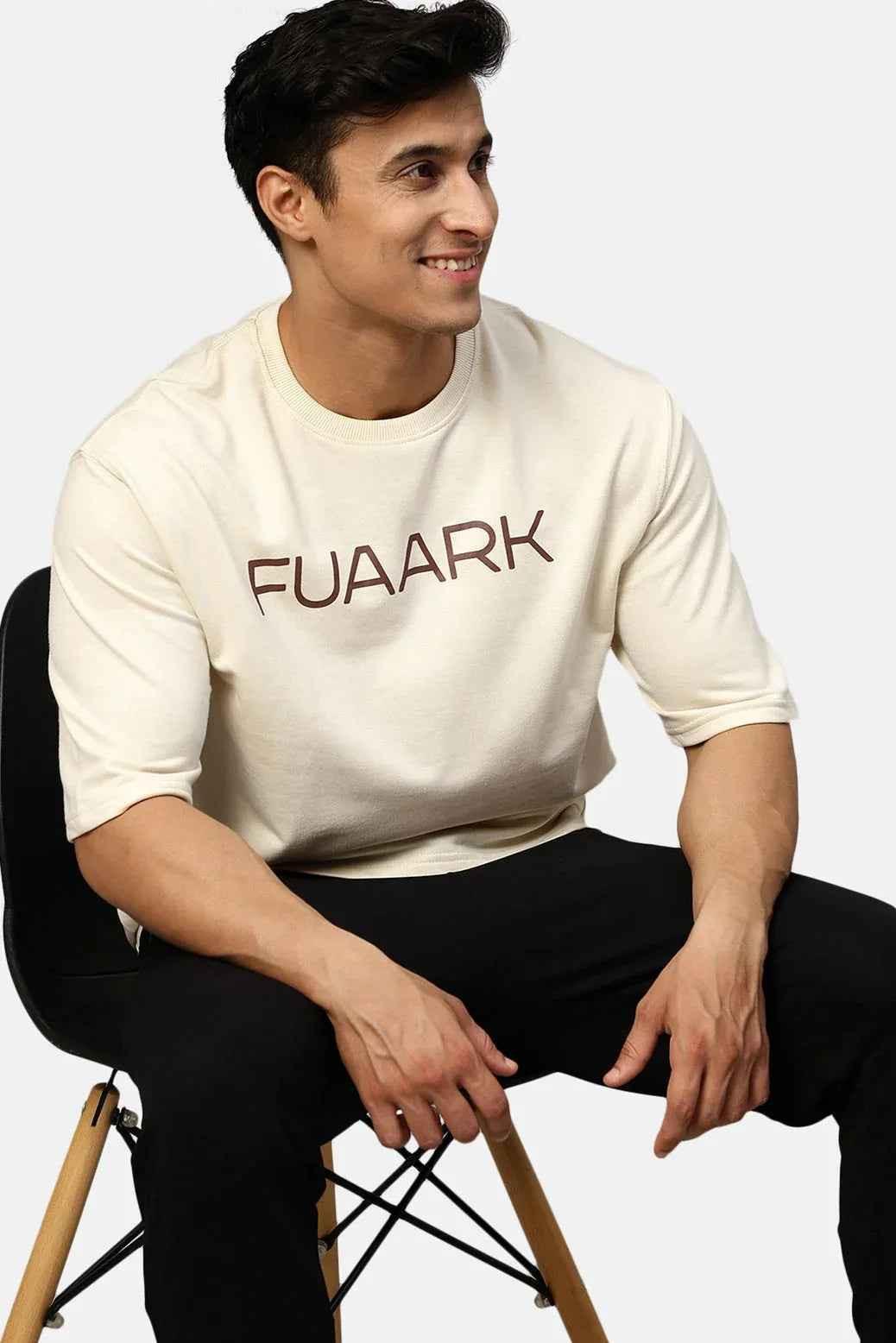 Beige oversized T-shirt by Fuaark Nz featuring a relaxed fit and casual style, shown on a plain background.