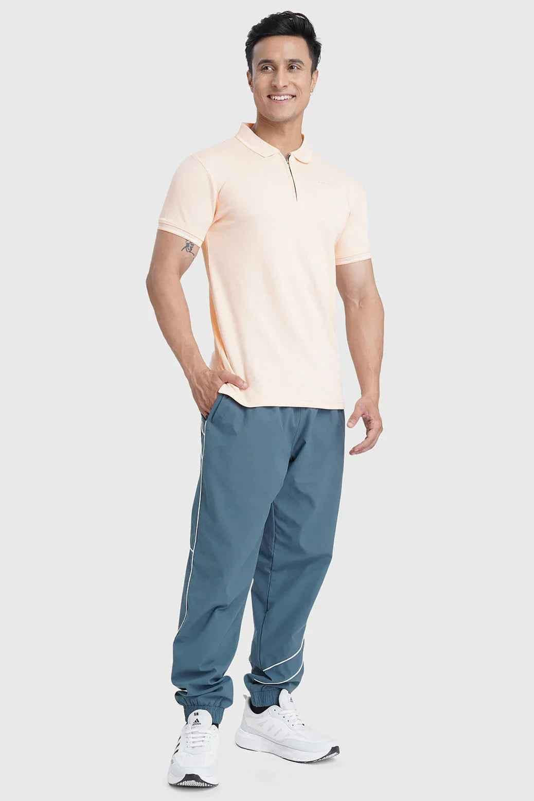 Fuaark Nz Heritage Polo T-shirt in peach, showing a casual short-sleeve cotton tee with a polo collar and subtle branding.