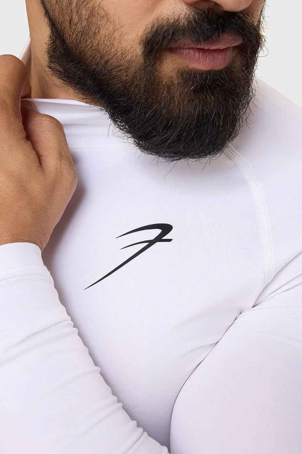White high neck compression full sleeves T-shirt by Fuaark Nz, showcasing a sleek, fitted design and comfortable fabric.