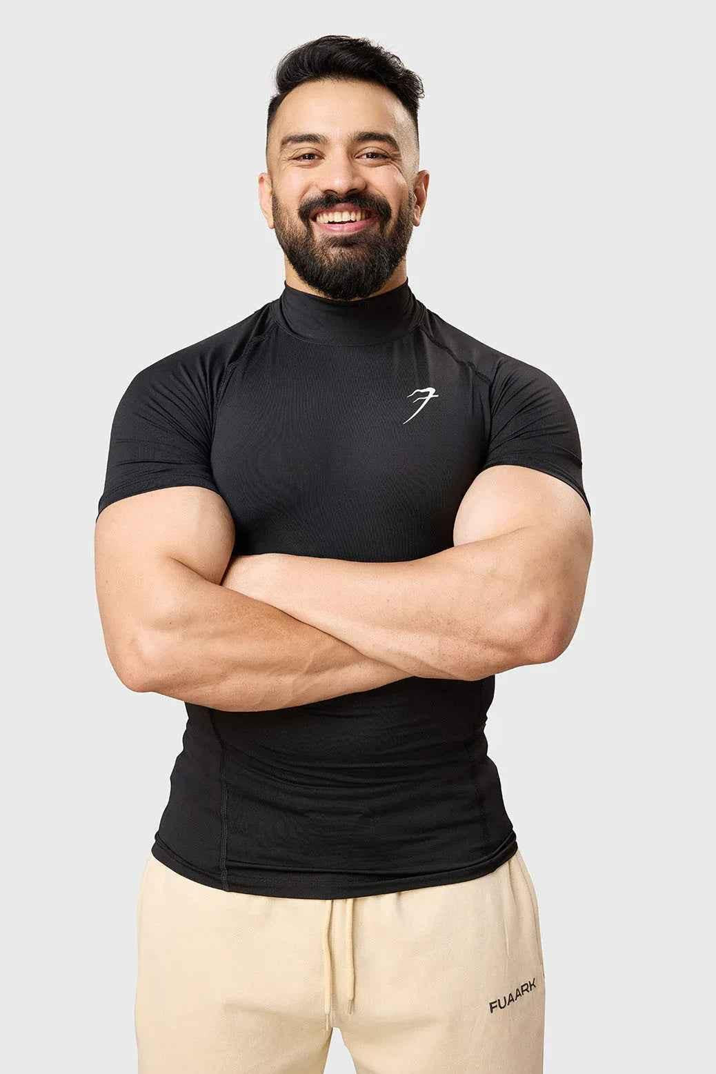 Black high neck compression T-shirt from Fuaark Nz, showcasing a fitted, sleek design ideal for active wear.