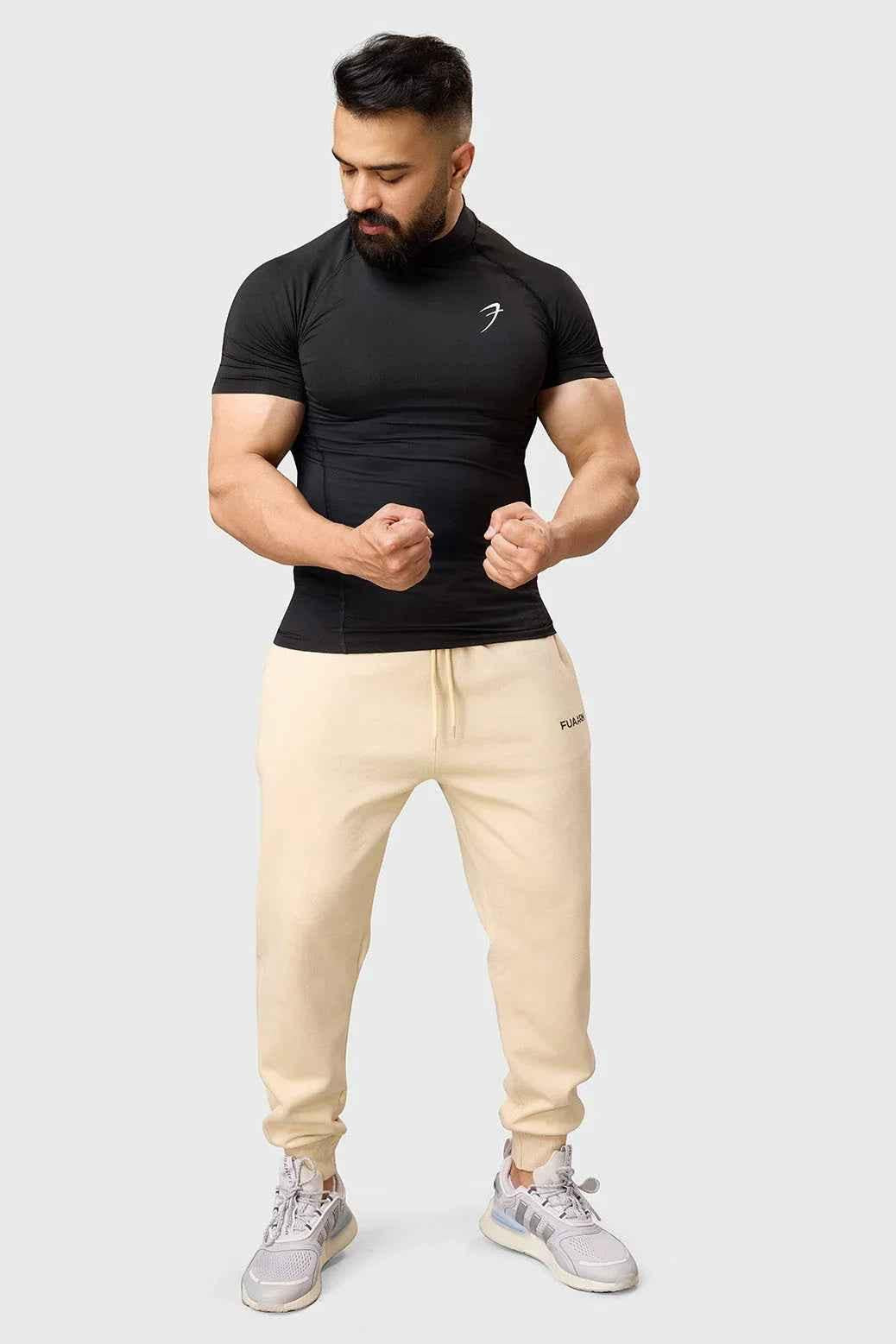 Black high neck compression T-shirt by Fuaark Nz, showcasing a snug fit and sleek design for athletic wear.