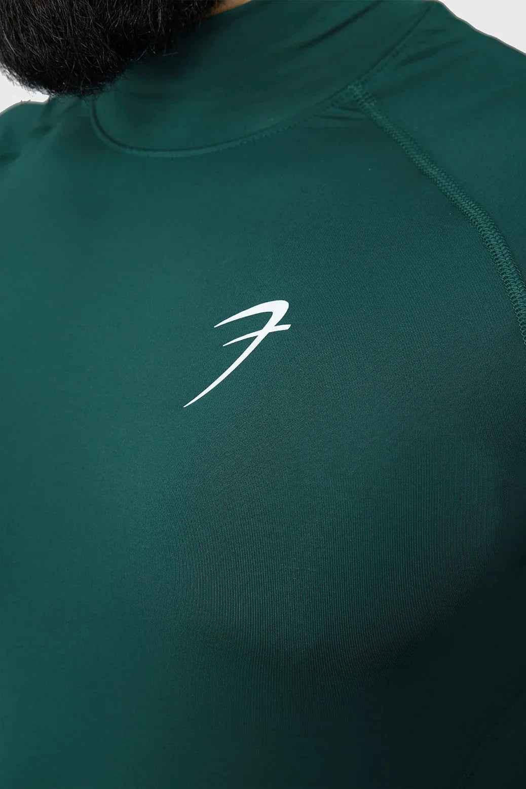 Emerald high neck compression T-shirt by Fuaark Nz, showcasing a fitted, stretchy design for athletic support and comfort.