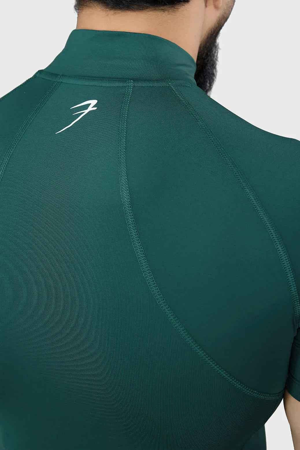 Emerald high neck compression T-shirt by Fuaark Nz, showcasing a snug fit and sleek design for active wear.