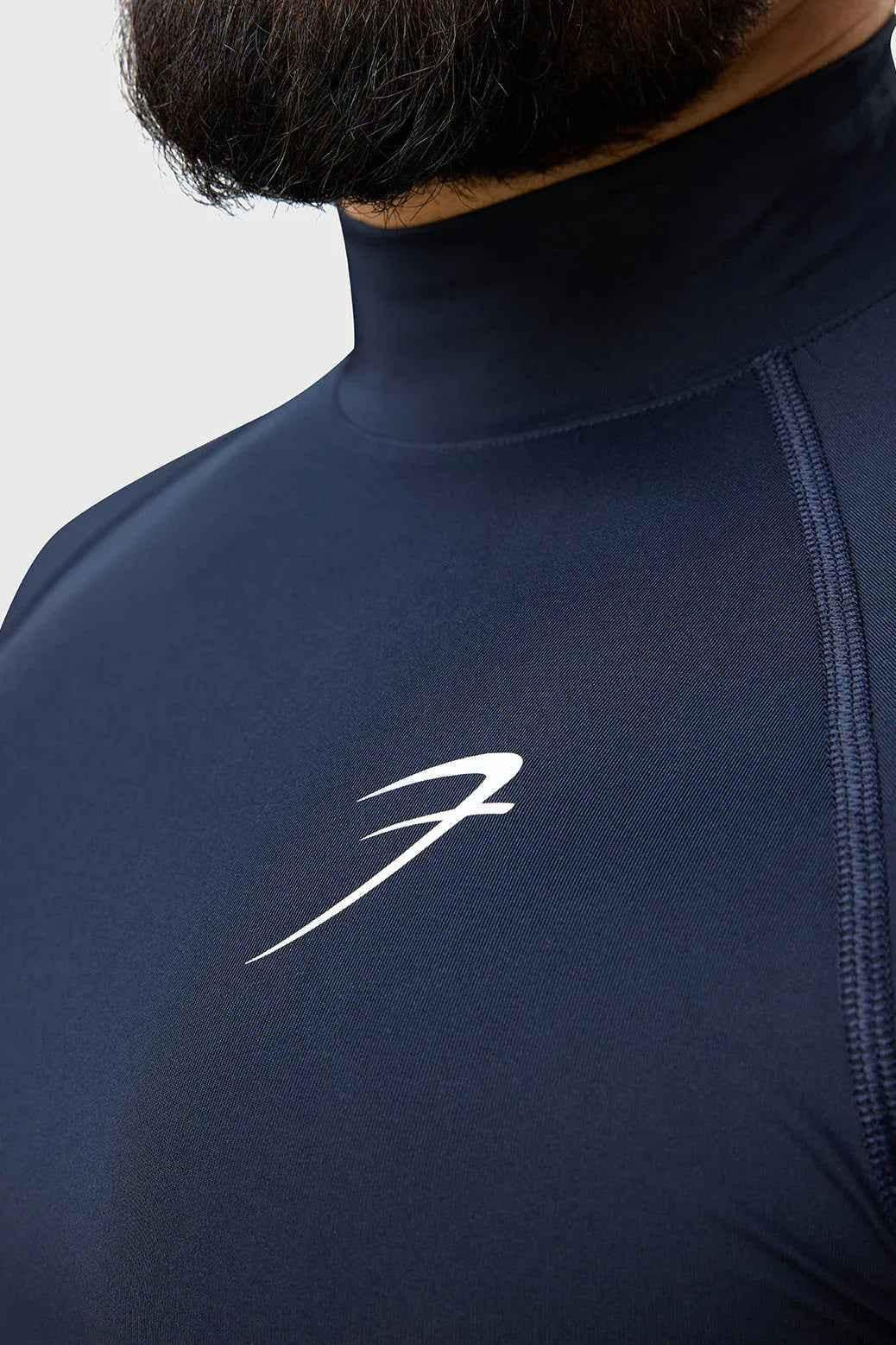 Navy high neck compression T-shirt by Fuaark Nz, close-up of the fitted, stretchy fabric and high collar design.