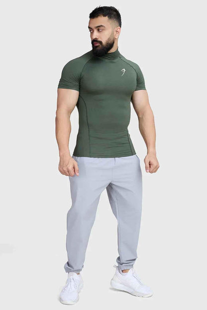 Olive high neck compression T-shirt by Fuaark Nz, close-up of fitted athletic shirt with high neckline and smooth fabric.
