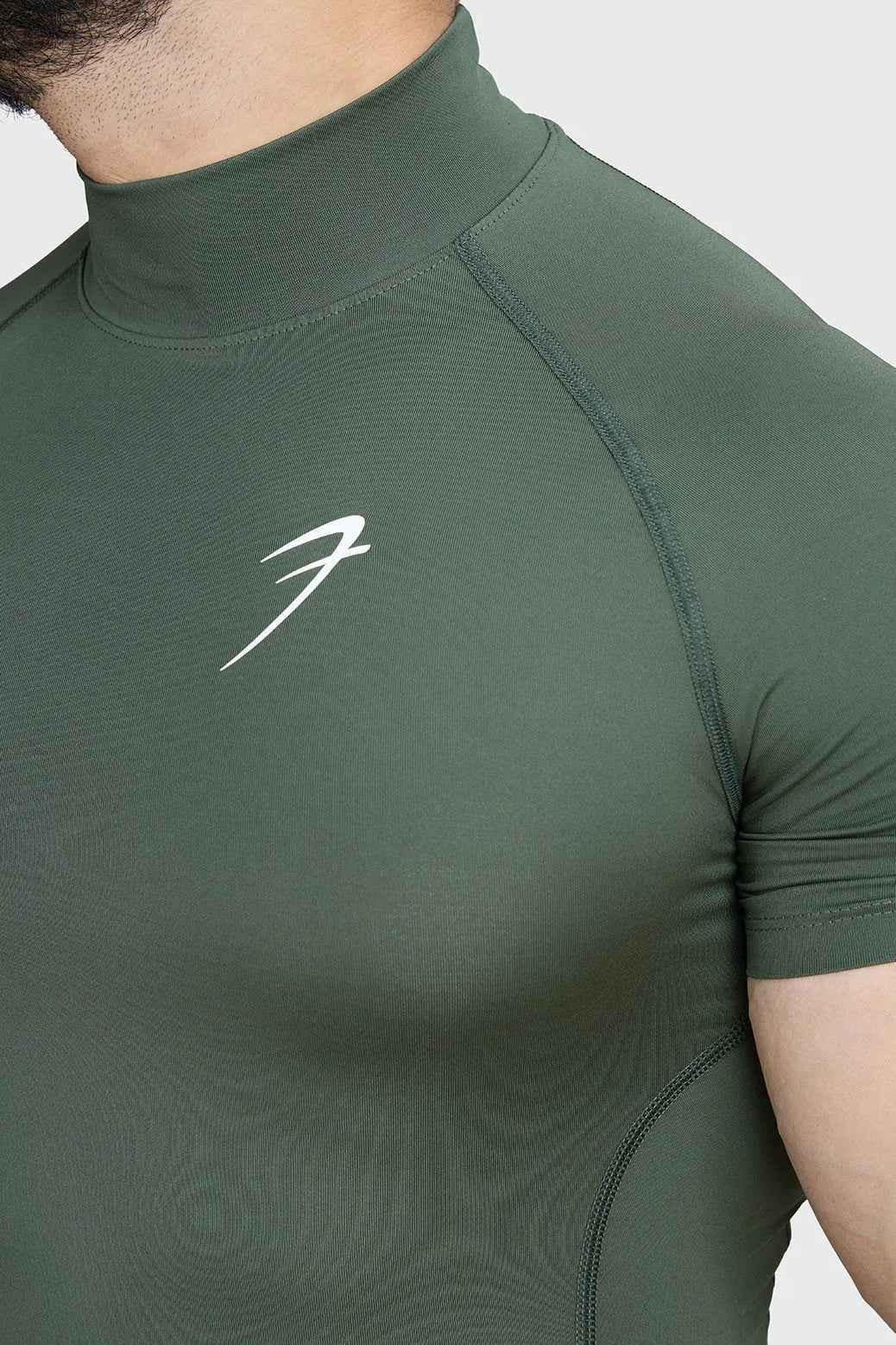 Olive high neck compression T-shirt by Fuaark Nz, showcasing a fitted design and soft fabric on a user.