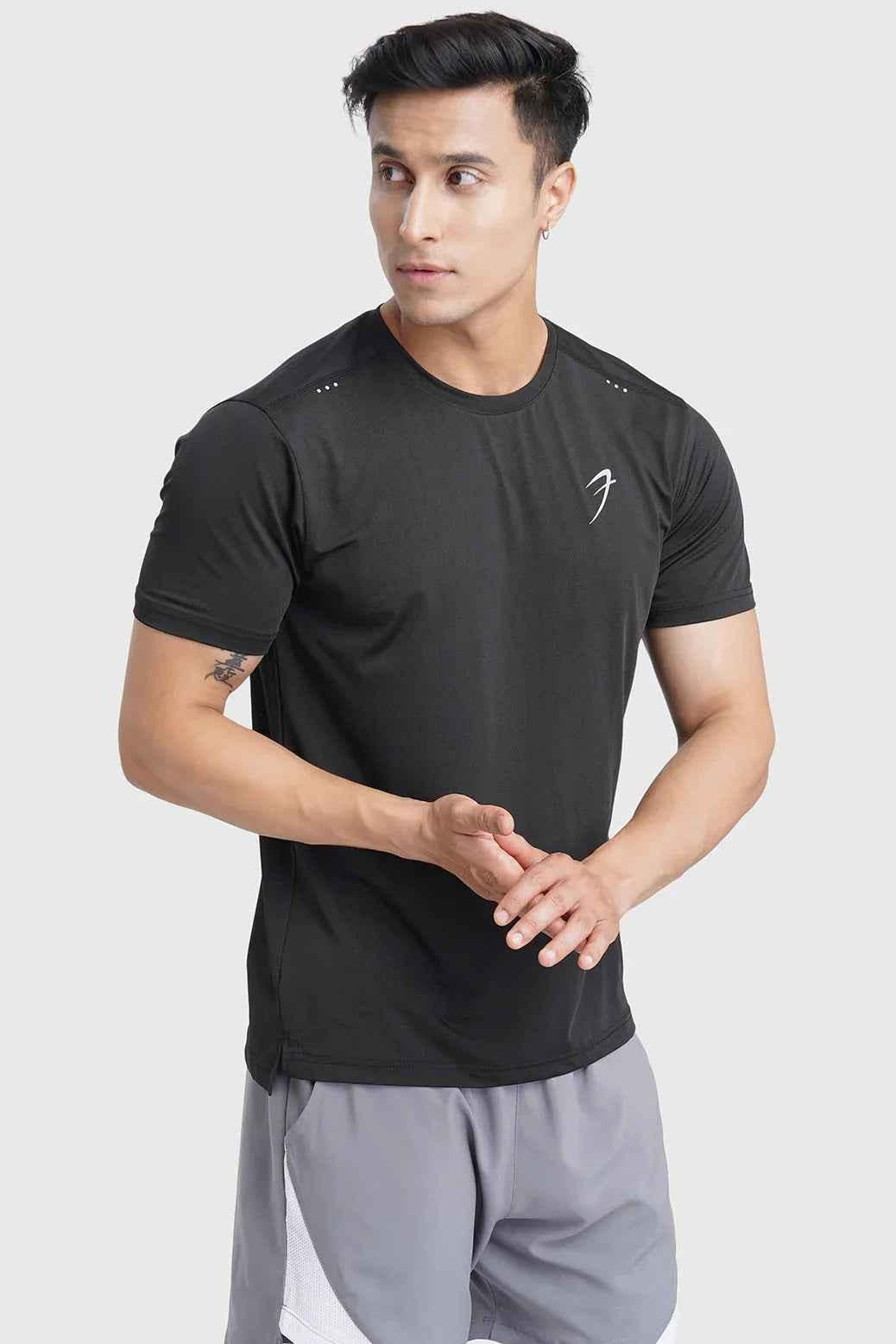 Black laser cut running T-shirt by Fuaark Nz featuring stylish cut-out details and breathable fabric for active wear.