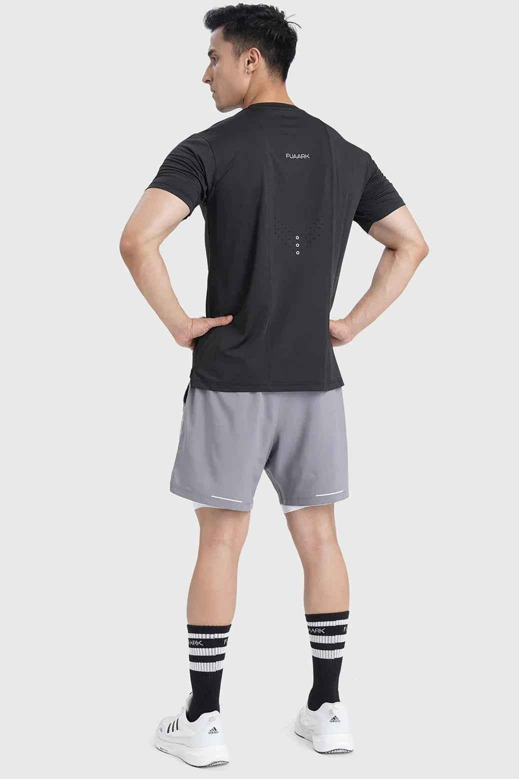Black laser-cut running T-shirt by Fuaark NZ, showcasing intricate cutout details and athletic fit for active wear.