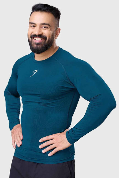 Men's teal compression long sleeve shirt by Fuaark Nz, breathable and quick-dry gym top, designed for active wear and workout comfort.
