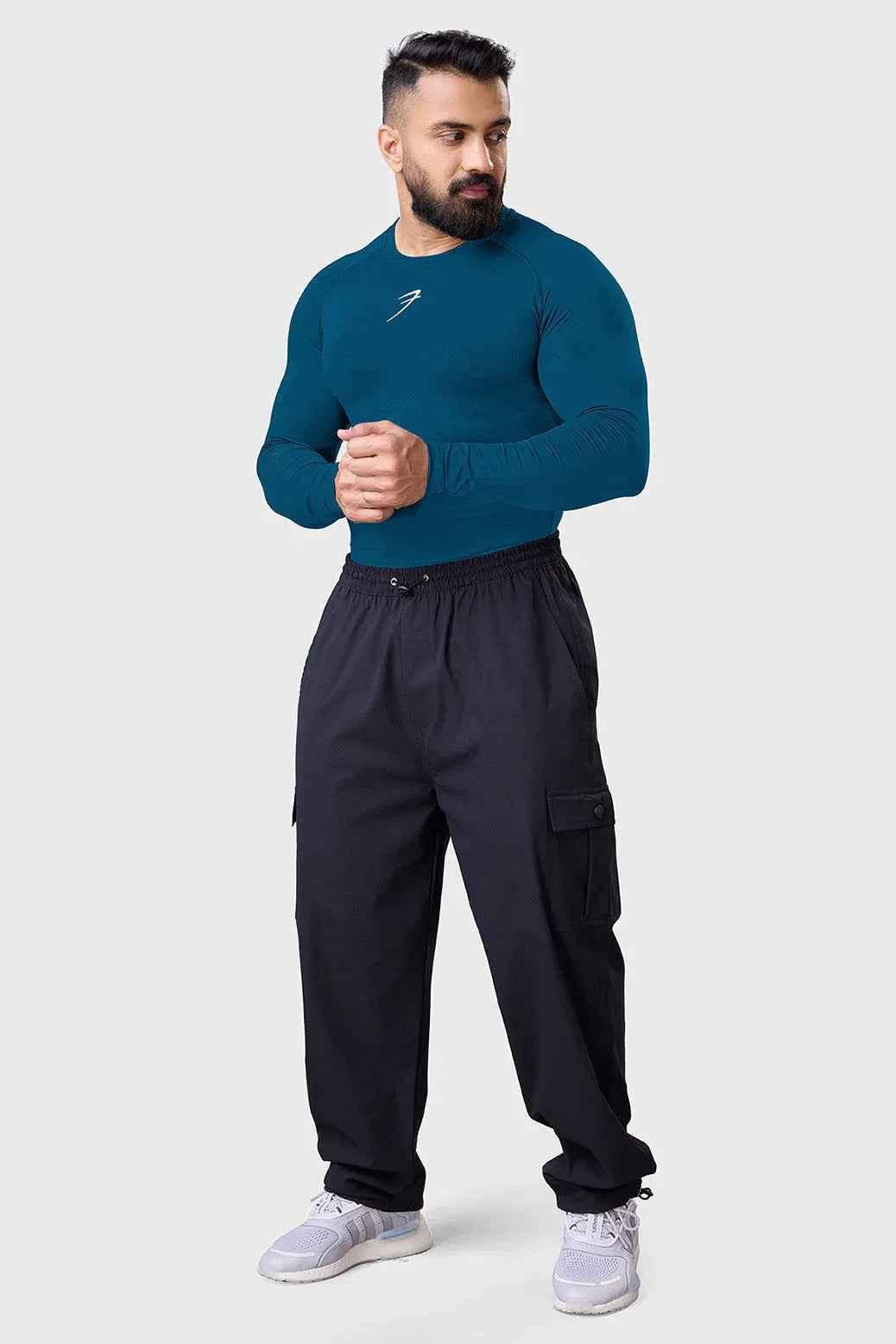 Men's teal compression long sleeve shirt by Fuaark NZ, breathable and quick-dry gym top, shown on a model.
