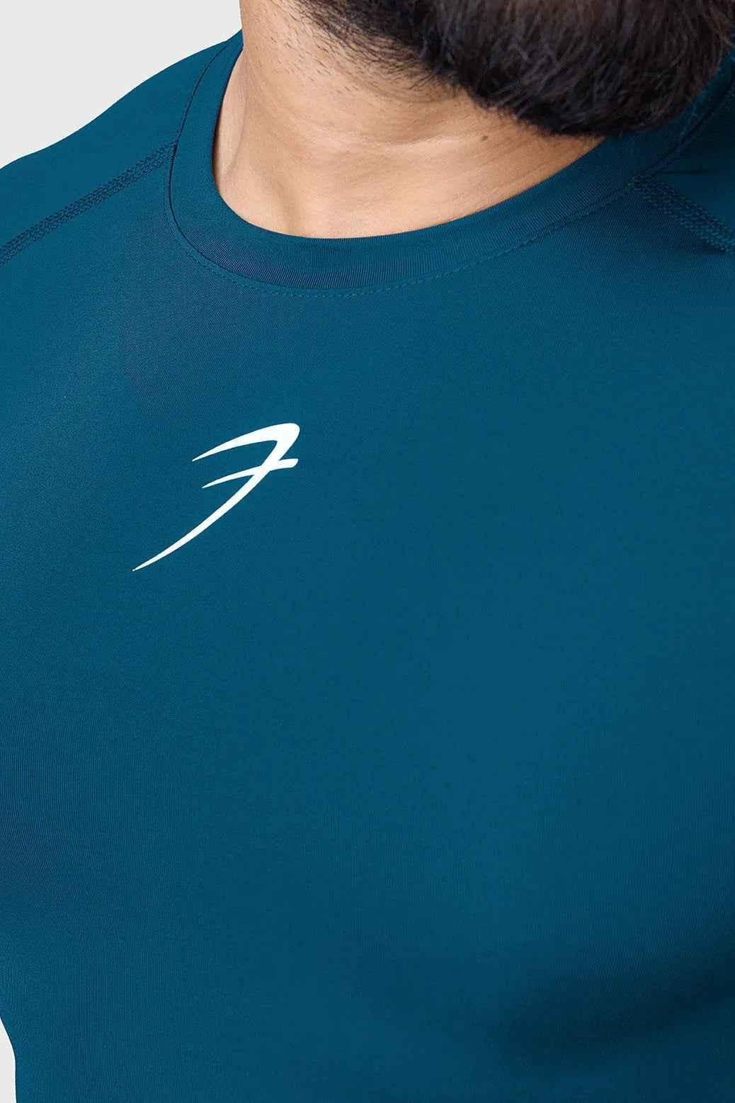 Men's teal compression long sleeve shirt by Fuaark NZ, breathable and quick-dry gym t-shirt for active wear.