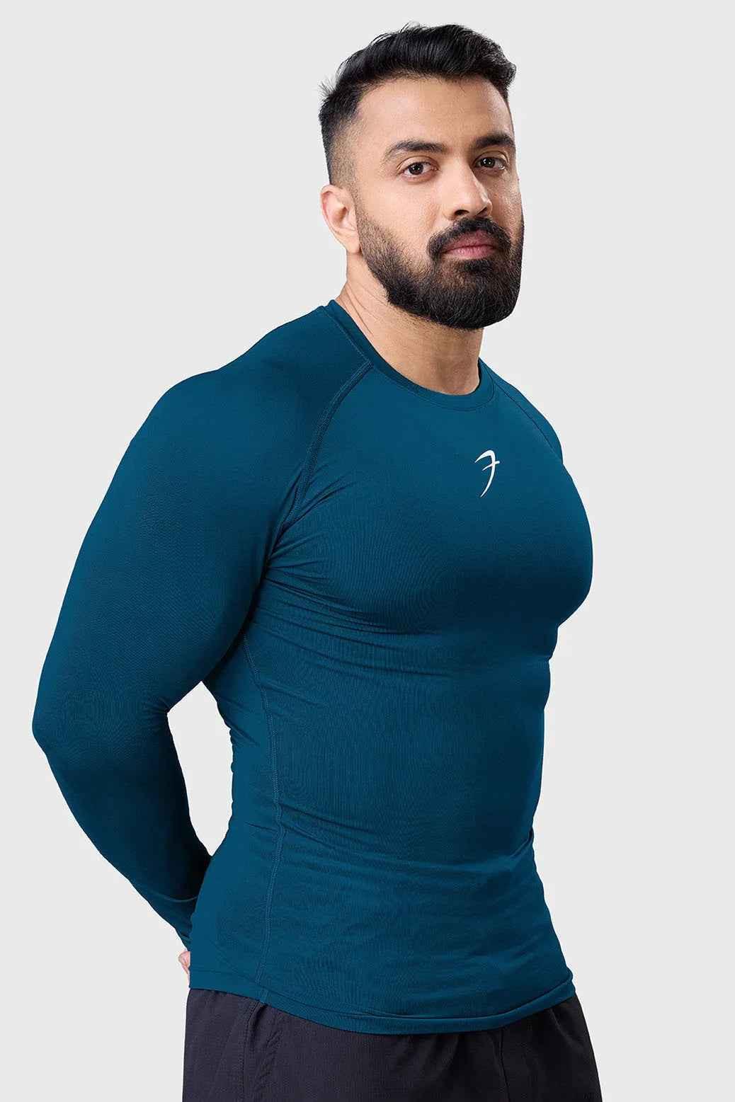 Men's teal compression long sleeve shirt by Fuaark NZ, breathable and quick-dry gym T-shirt designed for active wear.