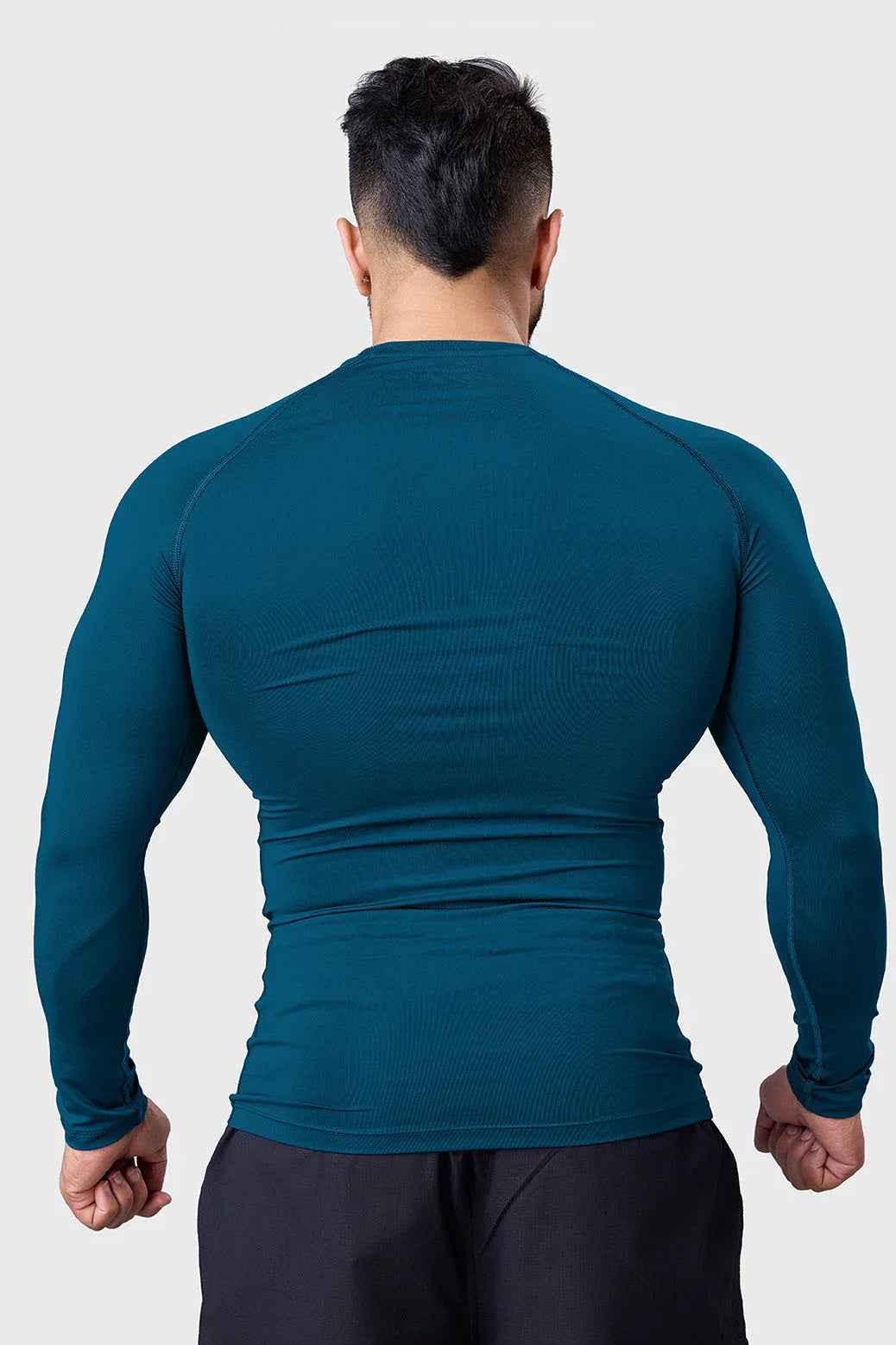 Men's teal compression long sleeve shirt by Fuaark NZ, breathable and quick-dry gym top designed for active wear.